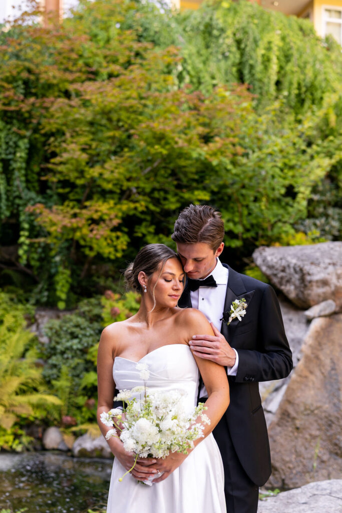 groom and bride pose together after first look at Alderbrook Resort and Spa