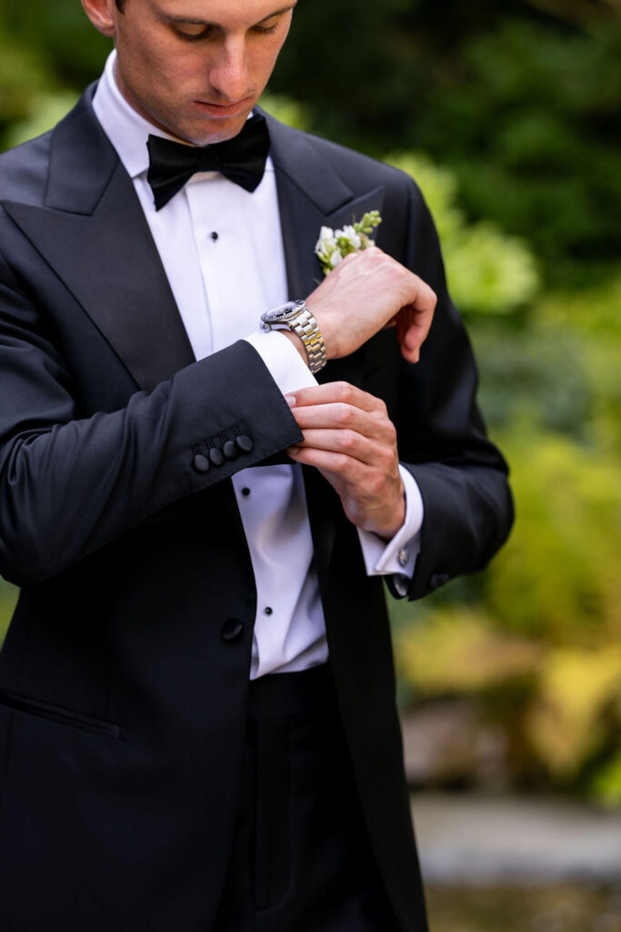 groom straightens cuffs
