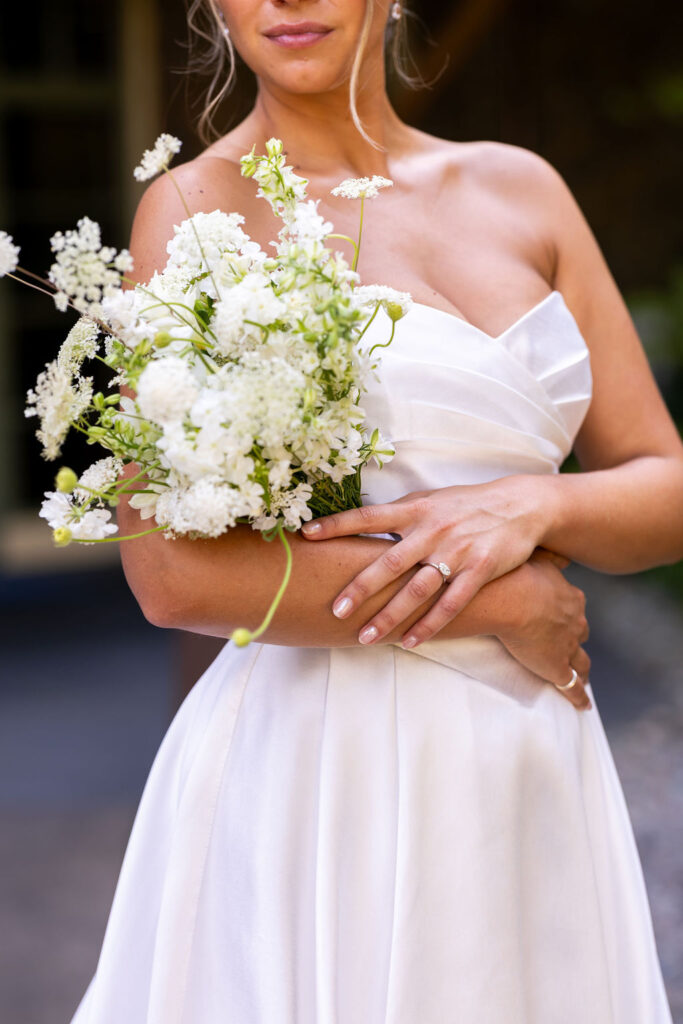 bride holds white flower bouquet