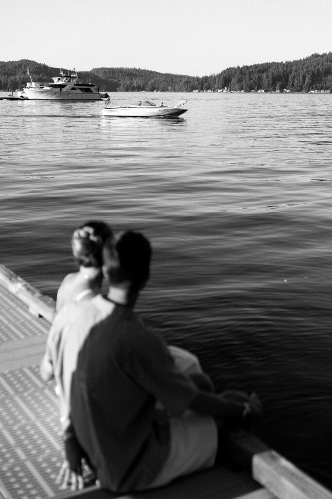 bride and groom looking out at water