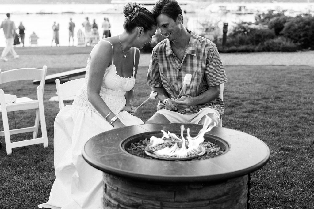 bride and groom making smores together