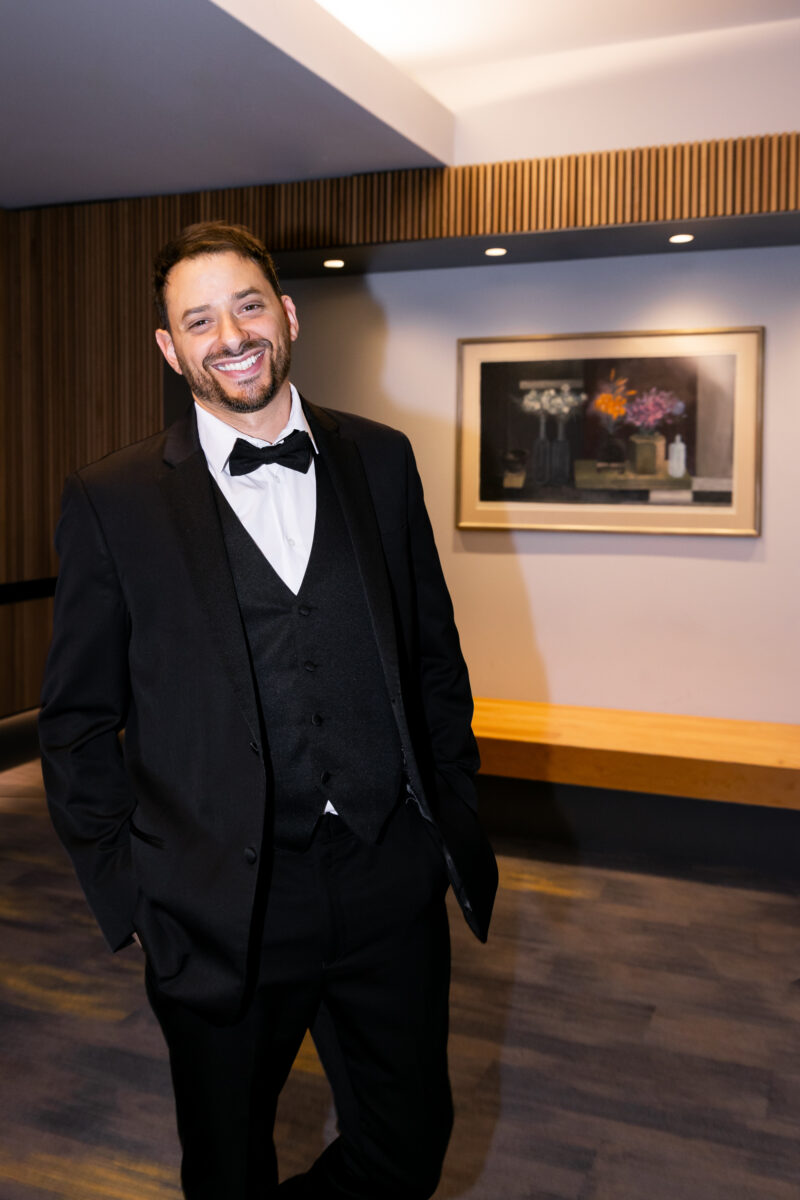 Groom smiling at Bell Harbor Conference Center before wedding ceremony