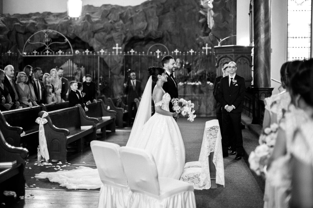bride and groom together after walking down the aisle staring of catholic wedding ceremony