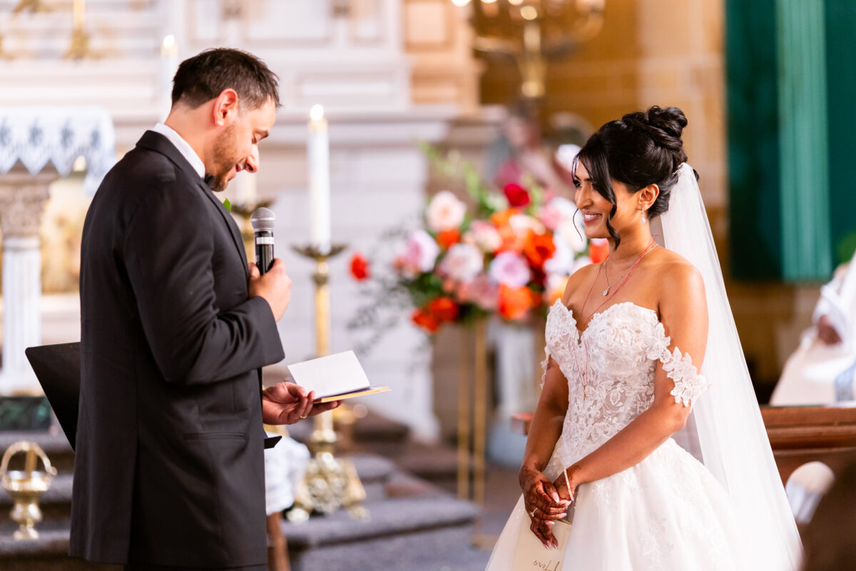 Groom reading vows to bride during catholic church wedding immaculate conception seattle
