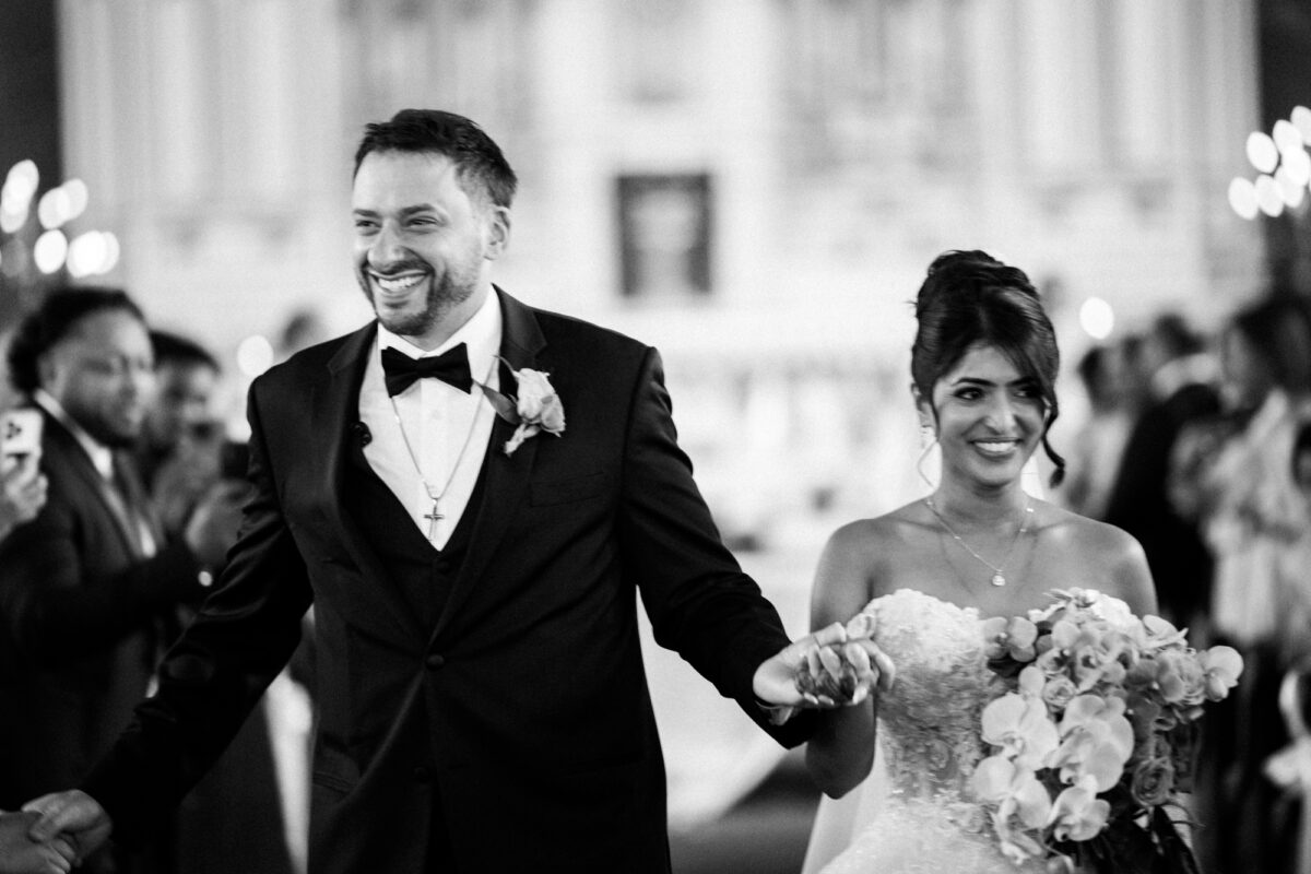 Bride and groom after getting married walking down aisle at immaculate conception seattle