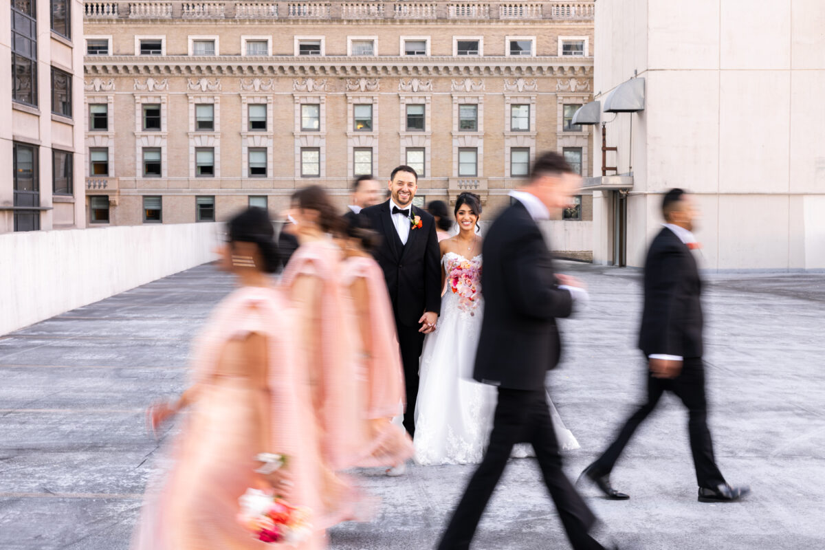 Bride and groom with wedding party on rooftop in downtown seattle