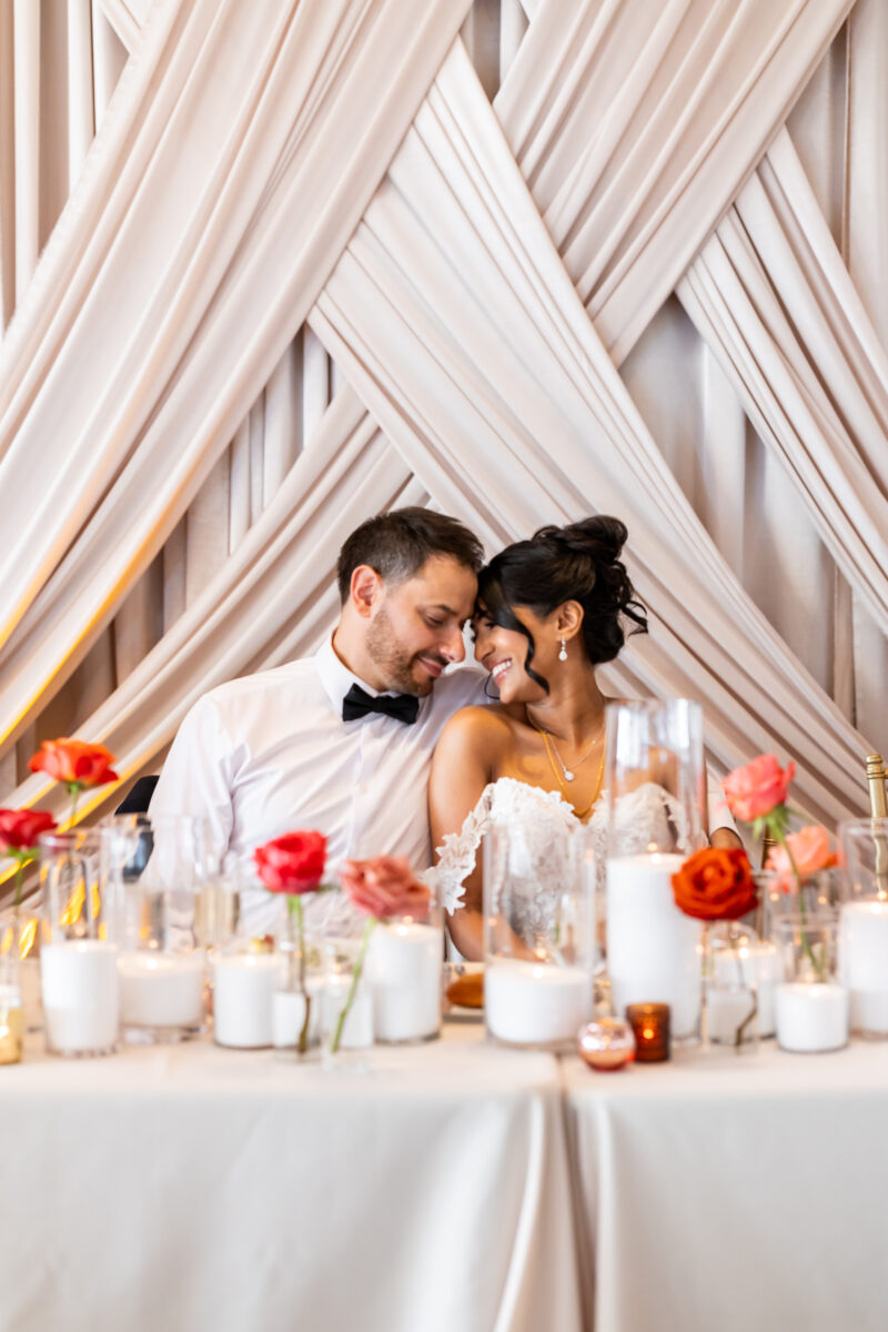 Bride and groom sitting down at table for bell harbor wedding reception seattle