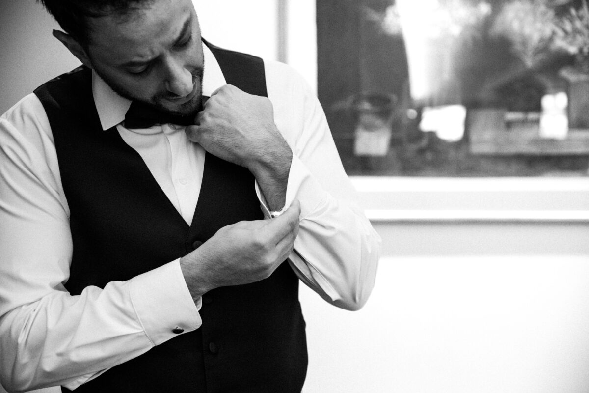 Groom putting on cuff links before Seattle wedding
