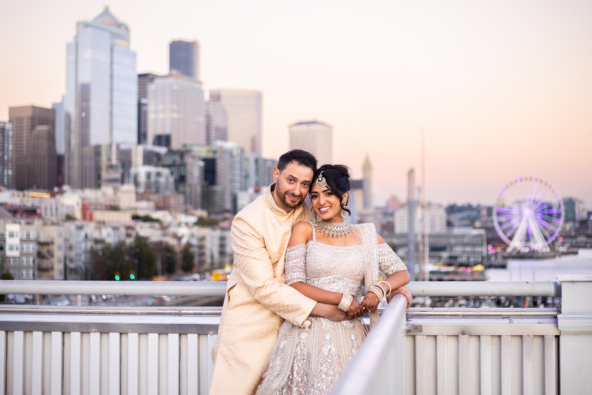 Bride and groom in Indian formalwear at rooftop of Bell Harbor Conference Center for Seattle waterfront wedding.