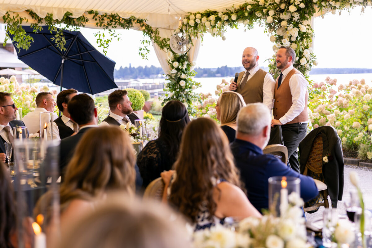 Two grooms thanking guests during woodmark hotel wedding reception