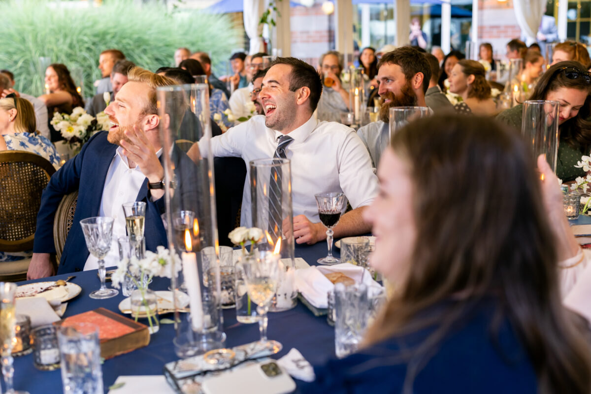 Guests laughing during wedding speeches