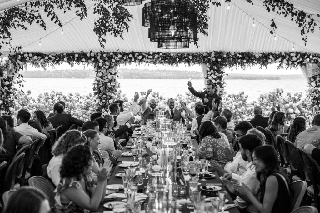 Guests raising glasses during speeches of Woodmark Hotel wedding reception