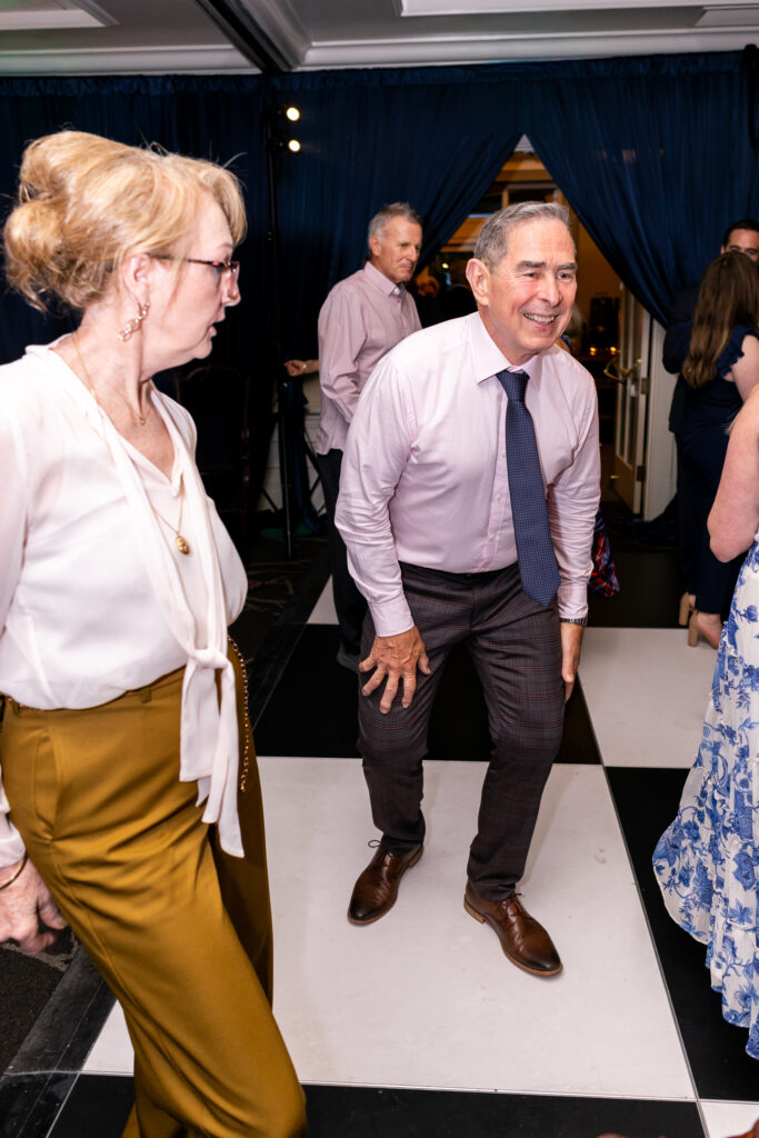 guests dancing during reception on checkered dance floor