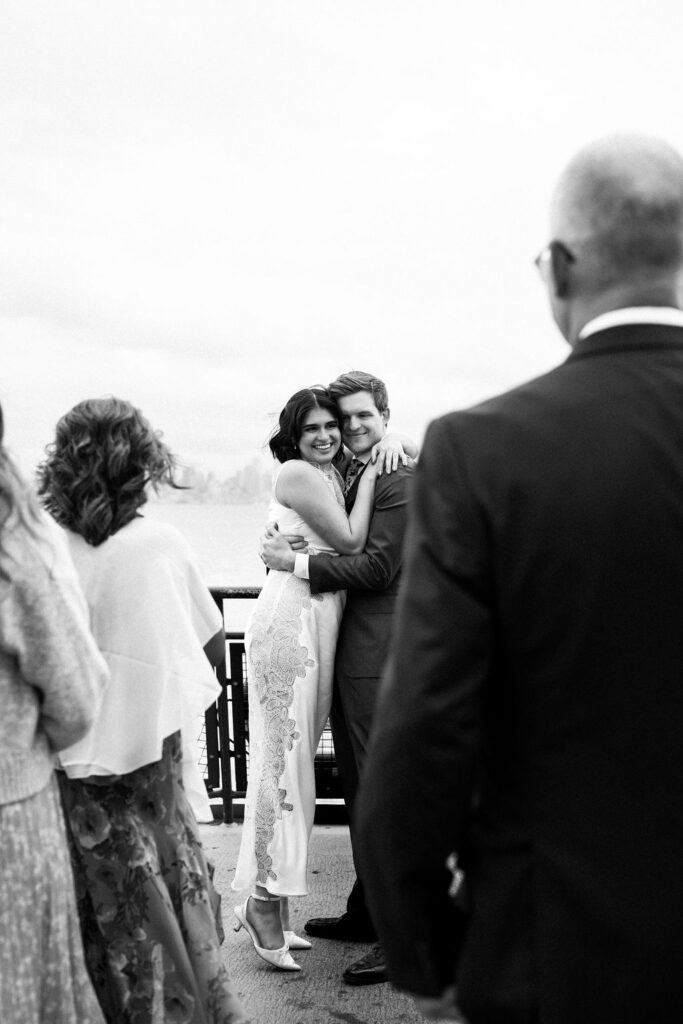 bride and groom snuggle on ferry
