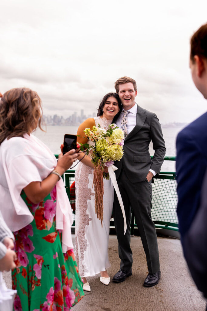 bride and groom snuggle on ferry