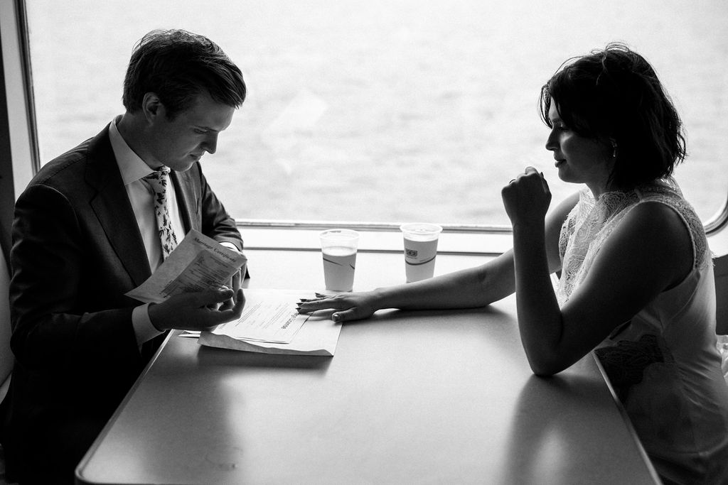 bride and groom sign marriage license on ferry