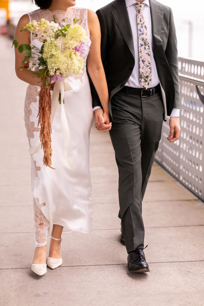 bride and groom walking on ferry dock