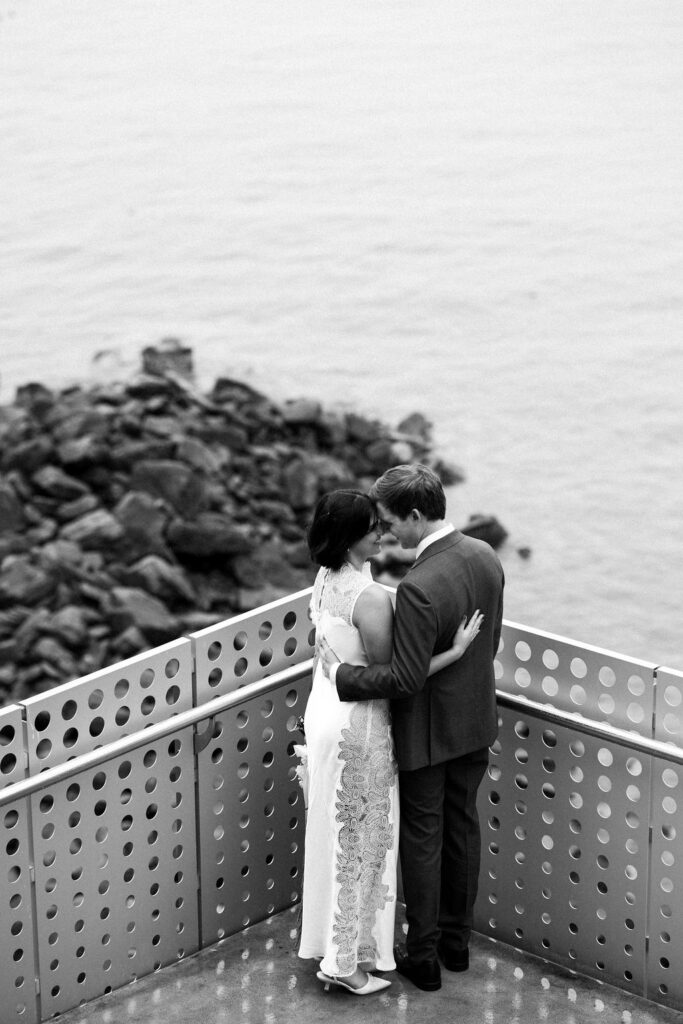 bride and groom with ocean in background