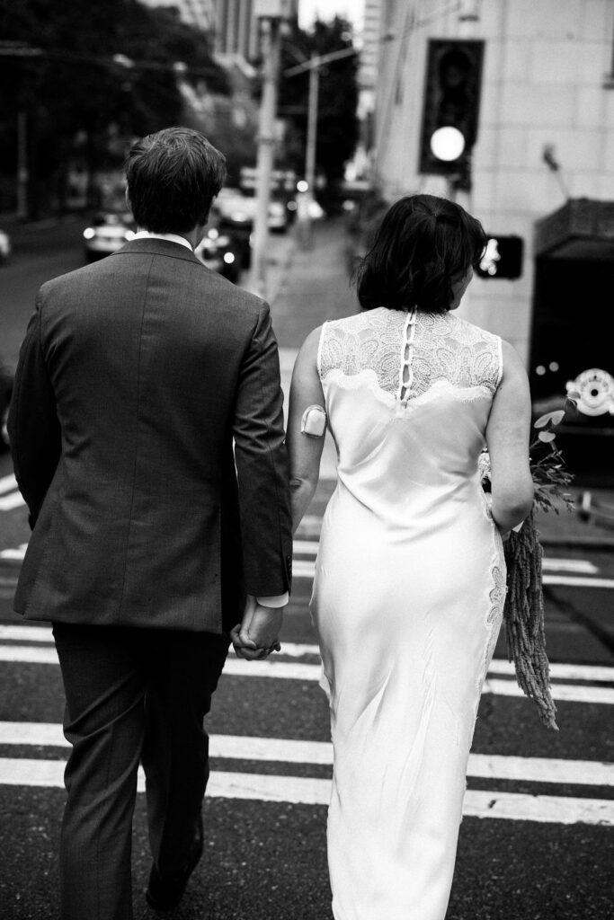 bride and groom walking through seattle