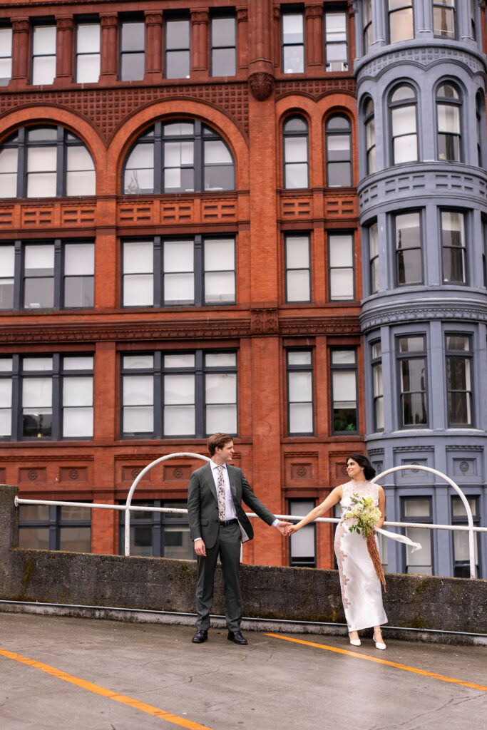 bride and groom with city in the background