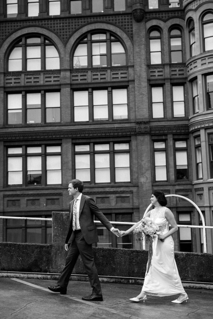 bride and groom with city in the background