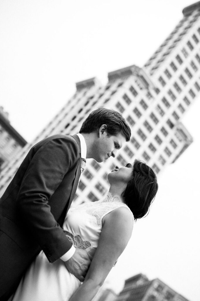 bride and groom with city in the background