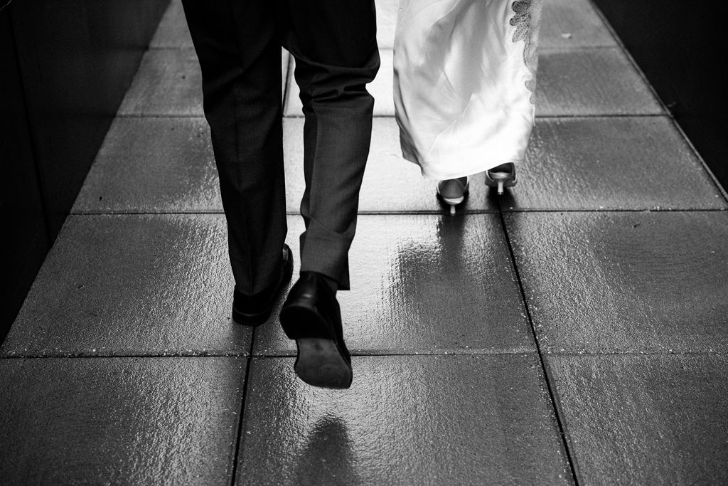bride and groom walking on concrete