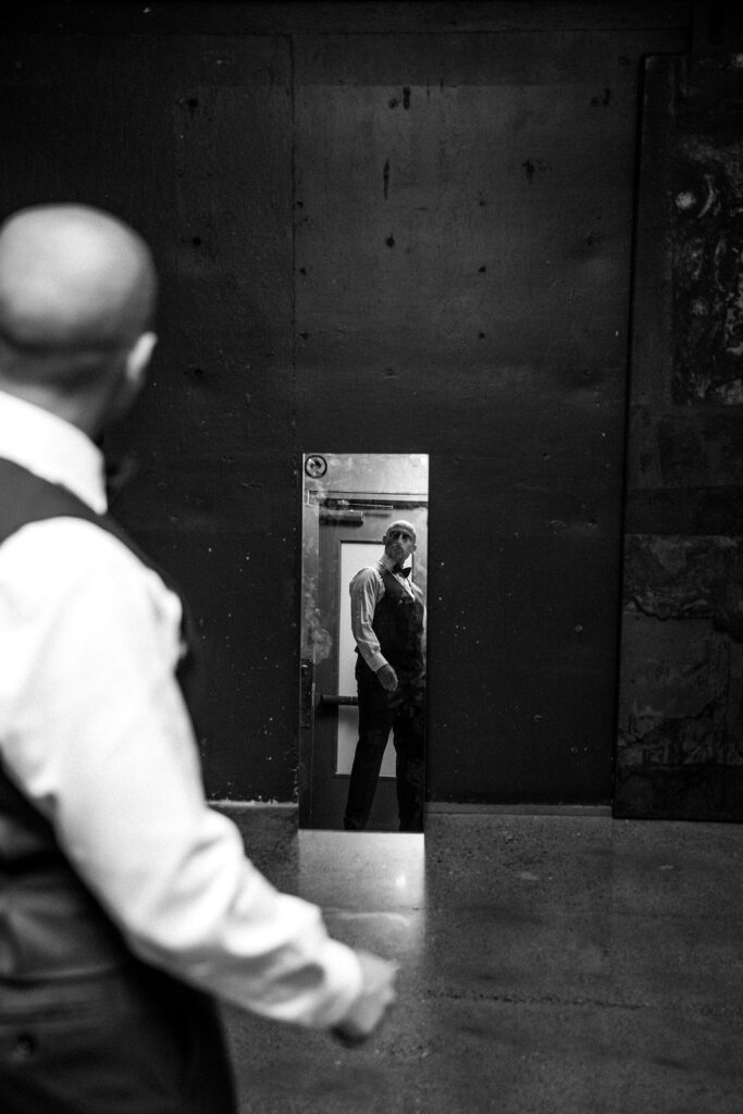 groom looking at himself in mirror