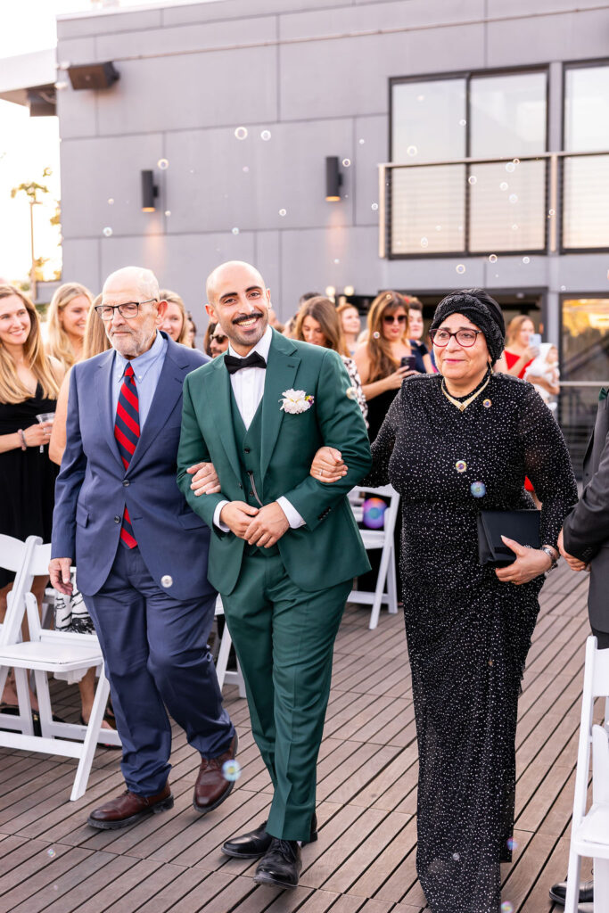 groom walks down aisle